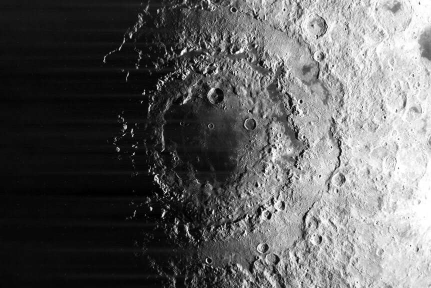 A craggy crater on the moon, seen top-down from high above