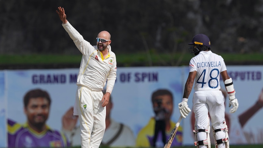 Australia bowler Nathan Lyon raise his hand to appeal to dismiss Sri Lanka batter Ramesh Mendis.