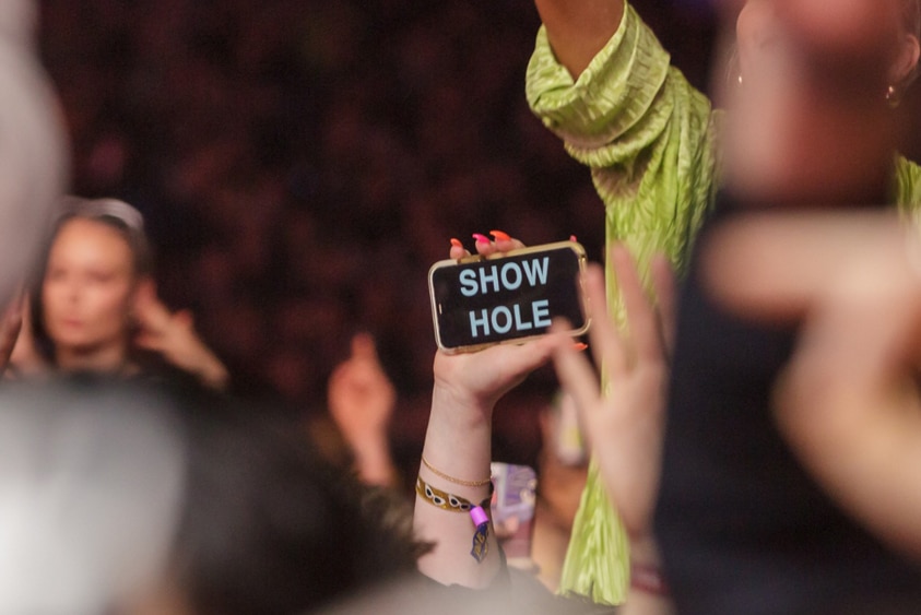 A smartphone with the message 'SHOW HOLE' during Jack Harlow's Splendour In The Grass 2022 set, Sat 23 July