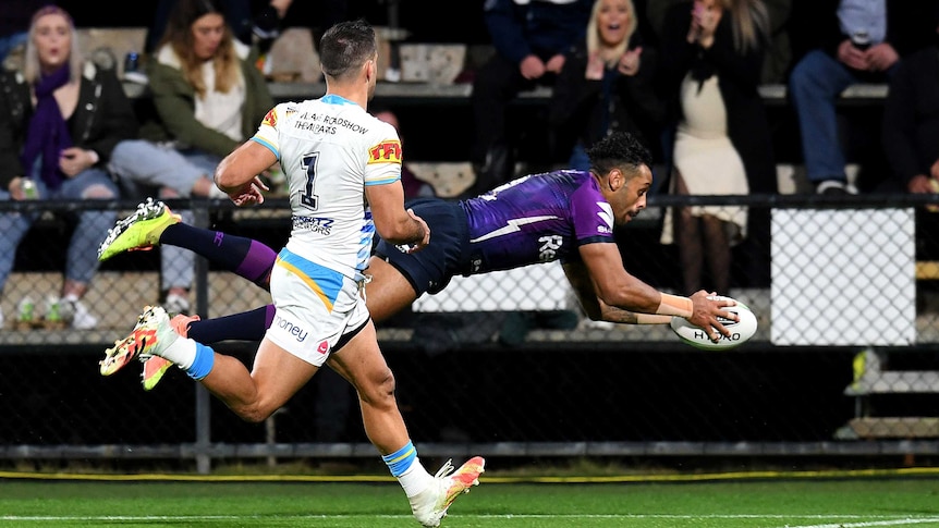 Melbourne Storm winger Josh Addo-Carr dives through the air for a try against the Gold Coast Titans.