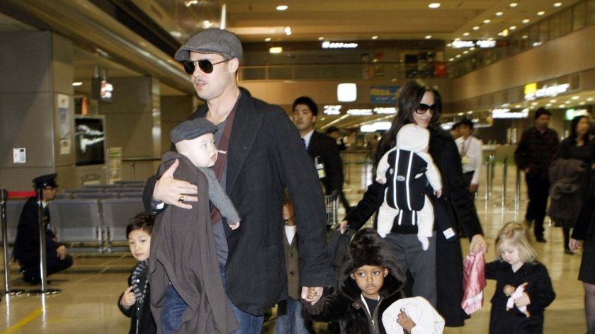 US actors Brad Pitt and Angelina Jolie arrive with their children at Tokyo's Narita airport on January 27, 2009, where Pitt is promoting the film 'The Curious Case of Benjamin Button'.