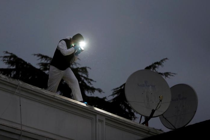 Turkish police forensic experts examine the roof of the residence of Saudi Arabia's consul-general.