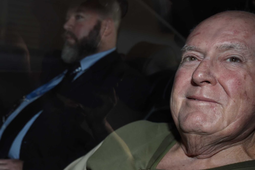 John Chardon being brought into the police watch house in Brisbane in a police car in June 2016.