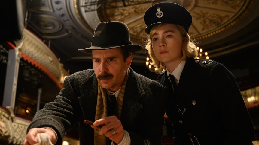 Inspector Stoppard (Sam Rockwell) and rookie Constable Stalker (Saoirse Ronan) lean over a piece of crime-scene evidence. 