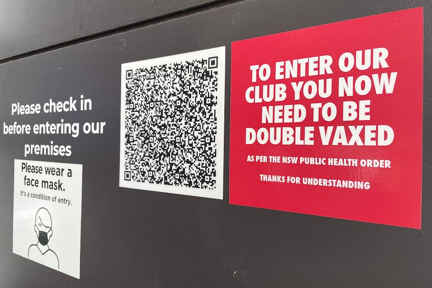 A QR code next to a sign saying "to enter our club you now need to be double vaxed".