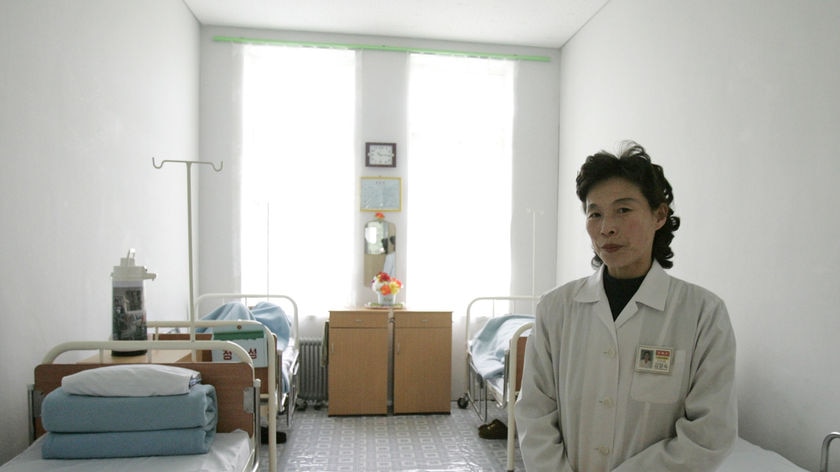 A North Korean nurse stands in a sickroom in a hospital in Pyongyang