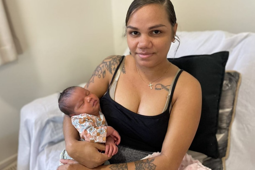 Shanara Fourmile, a 27-year-old First Nations woman from Yarrabah, nurses her one-week-old baby girl.