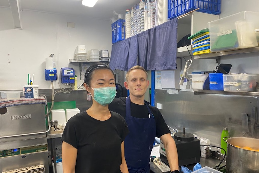 A woman and a man standing in a kitchen in NSW.