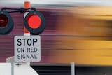 Freight train rushes through a level crossing