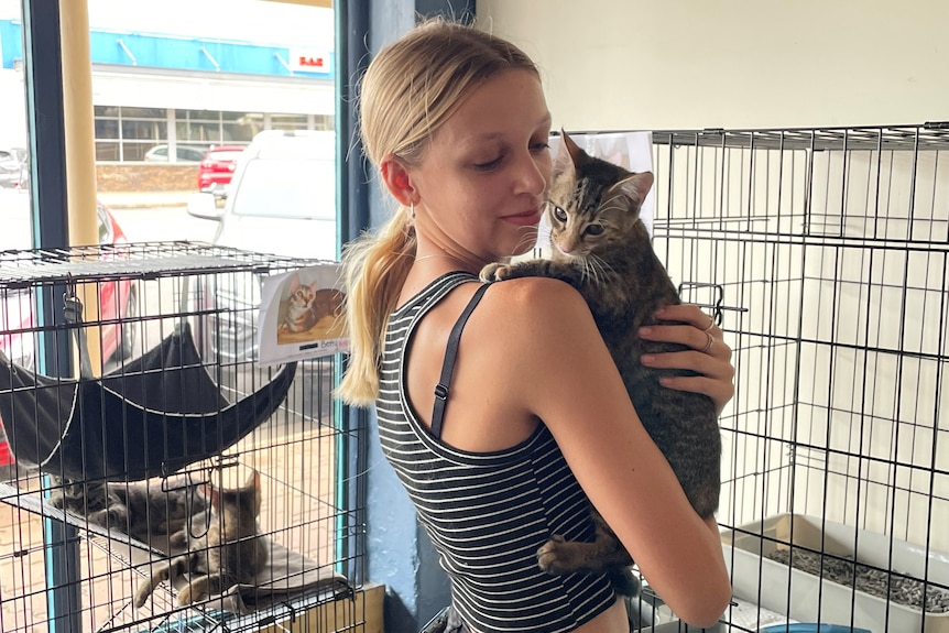 teenage girl holding rescued cat
