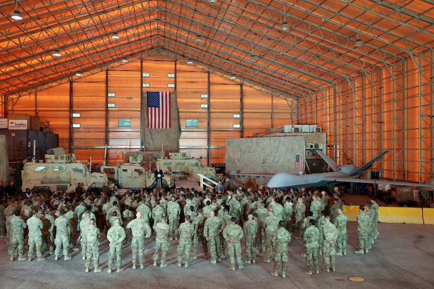 US troops and US military vehicles and Mike Pence inside Al-Asad airbase in Iraq