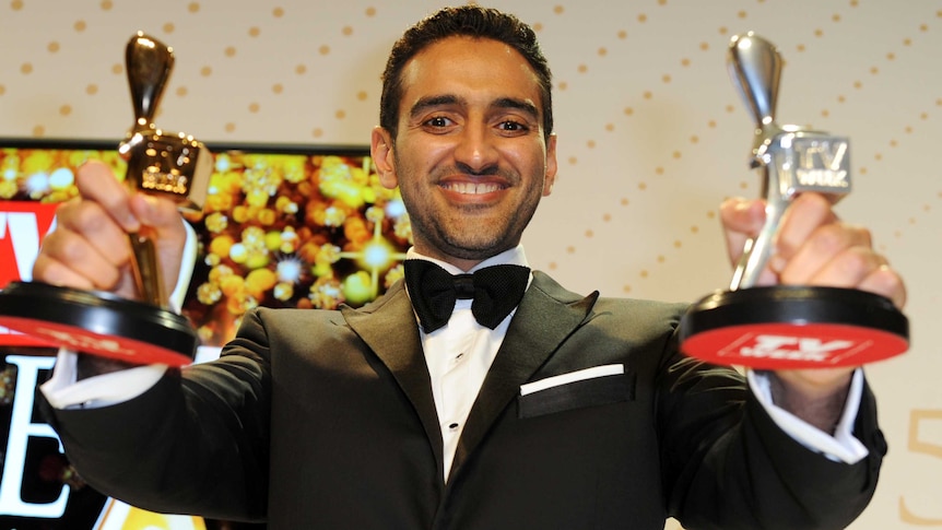 Waleed Aly with gold and silver trophies at the 2016 Logies.