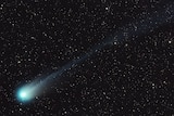 A green comet streaking through a star studded sky