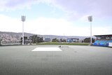 Hail covers the outfield at Bellerive Oval, making it appear white around the covered wicket block