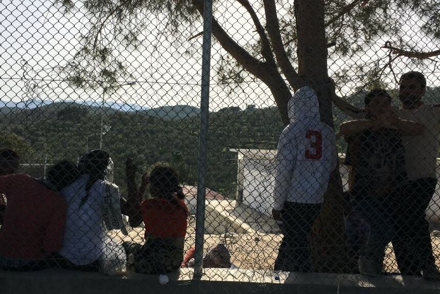 People at fence at Moria detention centre in Lesbos