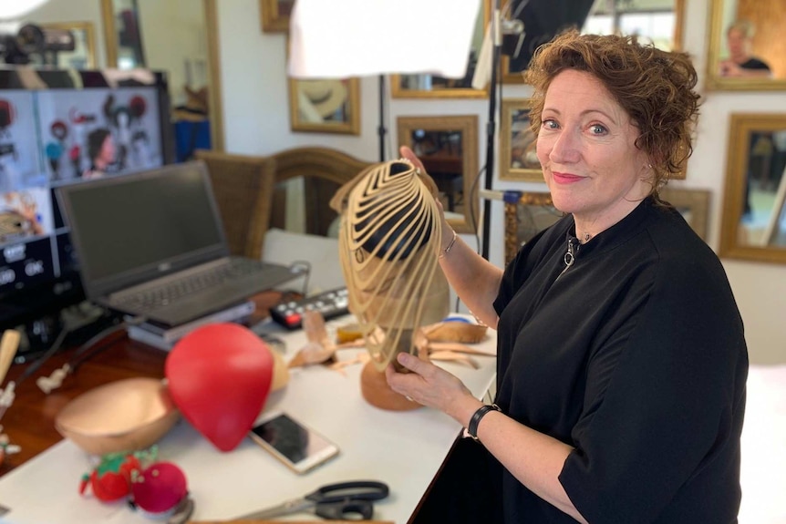 Carole Maher works on a headpiece in her studio workshop.