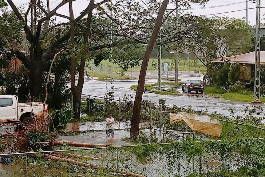 A backyard in a remote community covered in debris after floodwaters recede