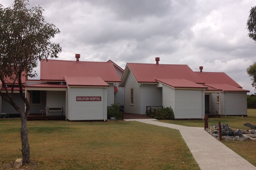 The exterior of the Woodman Point hospital with a sign saying "Isolation Hospital".