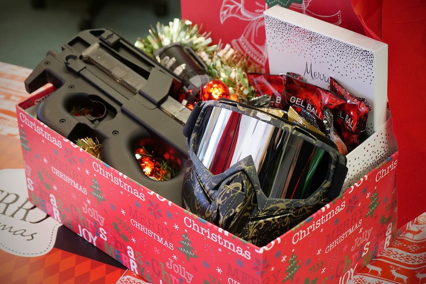 A gel blaster toy and goggles in a Christmas gift box