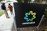 People stand outside a Centrelink office