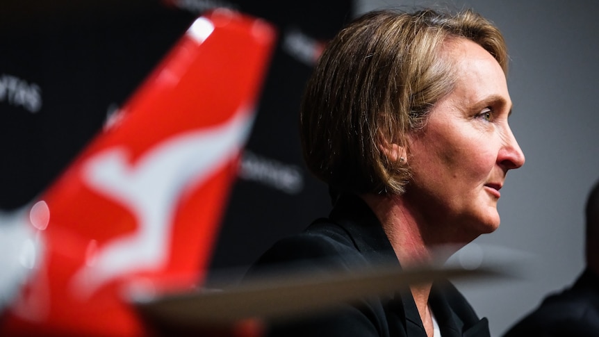 Vanessa Hudson, the incoming Qantas CEO, with model plane in foreground showing Flying Kangaroo