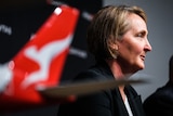 Vanessa Hudson, the incoming Qantas CEO, with model plane in foreground showing Flying Kangaroo