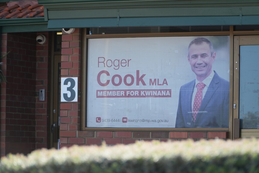 A building with the picture and name of WA Premier Roger Cook in the window.