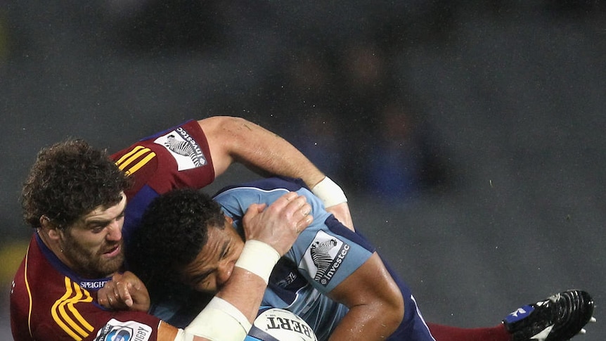 Bruising encounter ... the Blues' Peter Saili is tackled by Highlander Jamie Mackintosh at Eden Park.