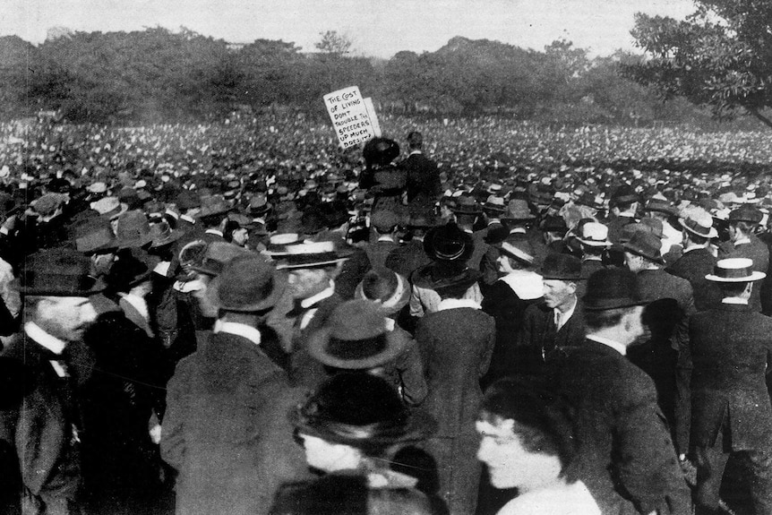 Photograph of a gathering of 100,000 men and women in park lands. black and white