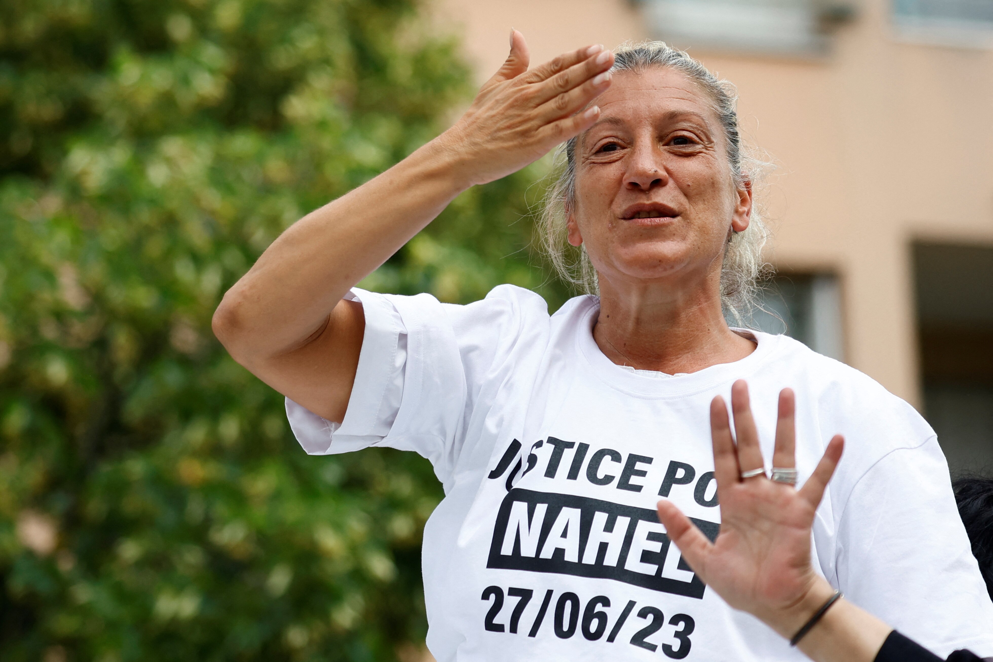 A woman wearing white t-shirt during a protest. 