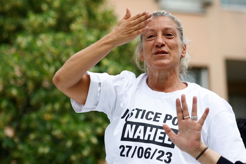 A woman wearing white t-shirt during a protest. 