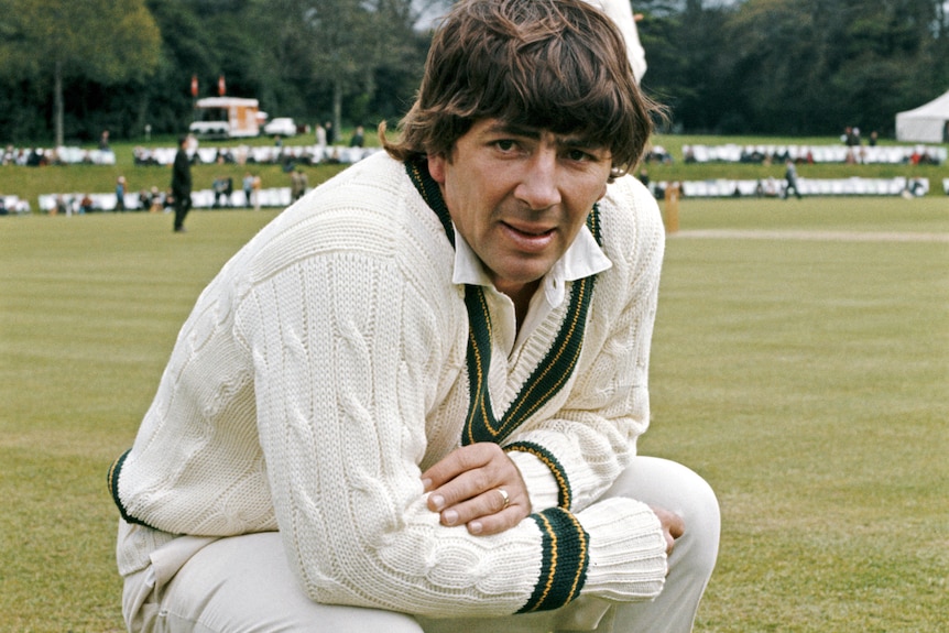 Rod Marsh crouches down in his cricket whites