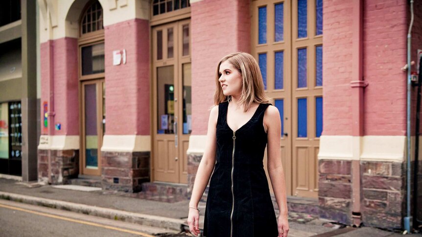 Country music singer Taylor Pfeiffer outside a building