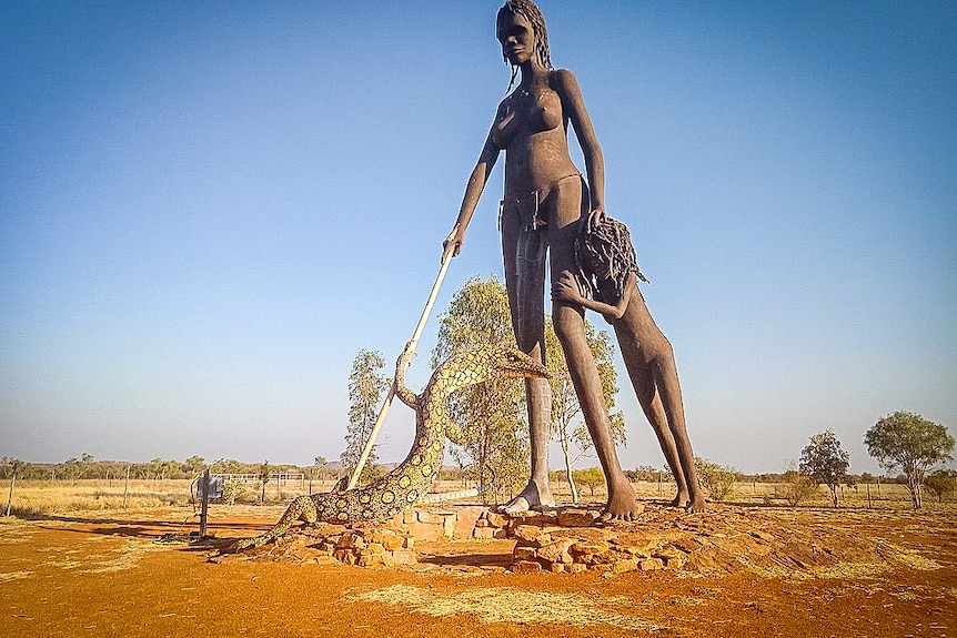 Huge statue of an Aboriginal woman and a child in the outback.
