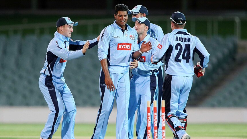 New South Wales players congratulate Gurinder Sandhu.