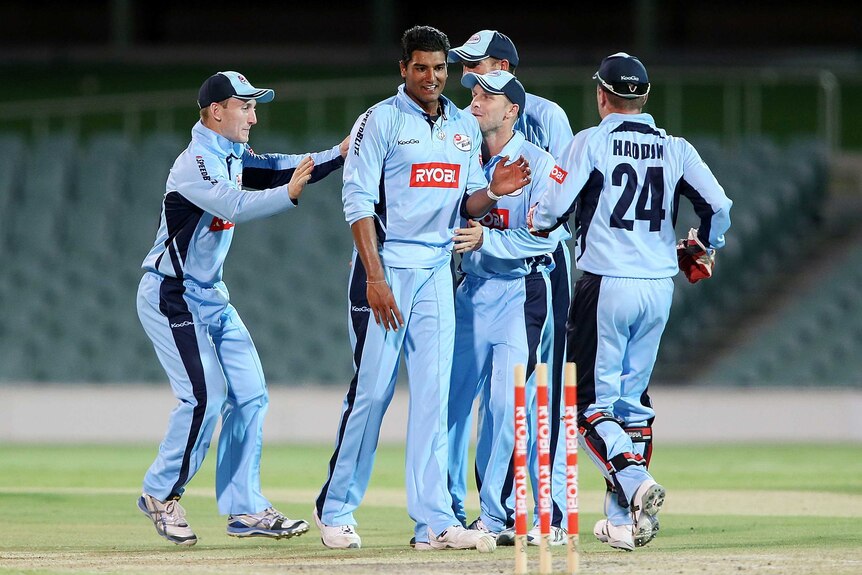 New South Wales players congratulate Gurinder Sandhu.