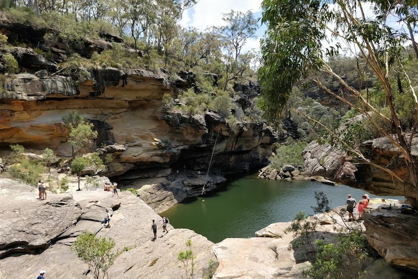 People look down on a big water hole