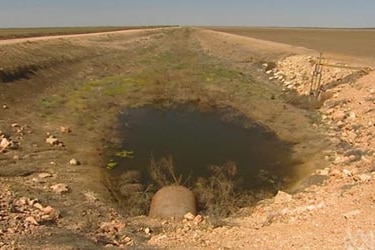 A dam lies empty on a cotton farm in southern Queensland