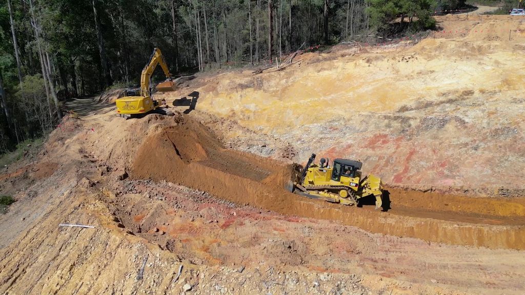Heavy equipment moving earth.