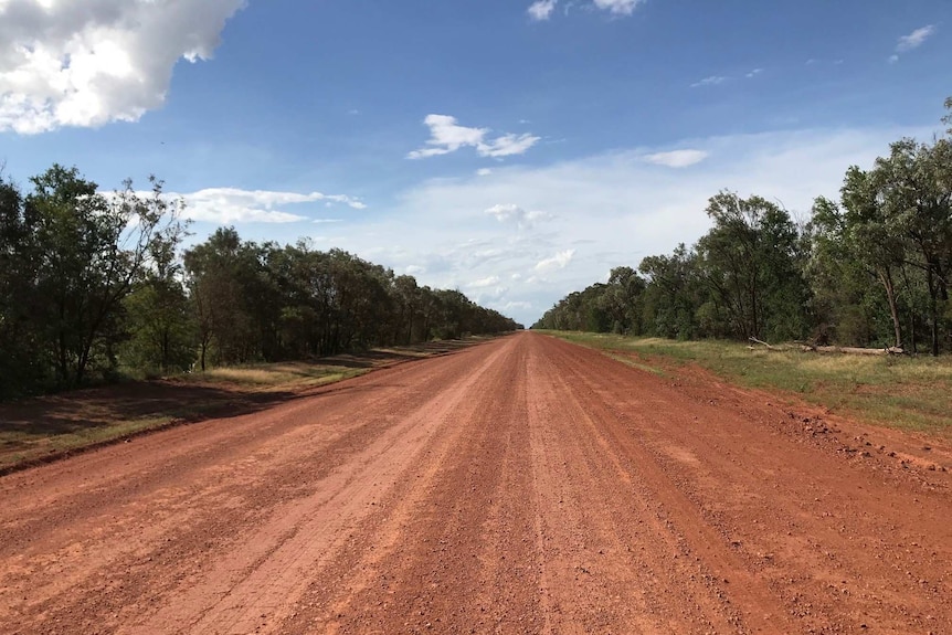 a red dirt road in a rural location