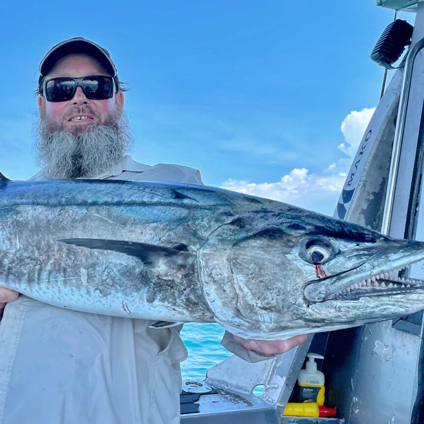 Stoked fisho holding a large spanish mackerel