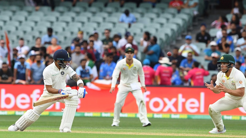 India batsman Virat Kohli watches the ball heading towards the waiting hands of Australian fielder Aaron Finch.