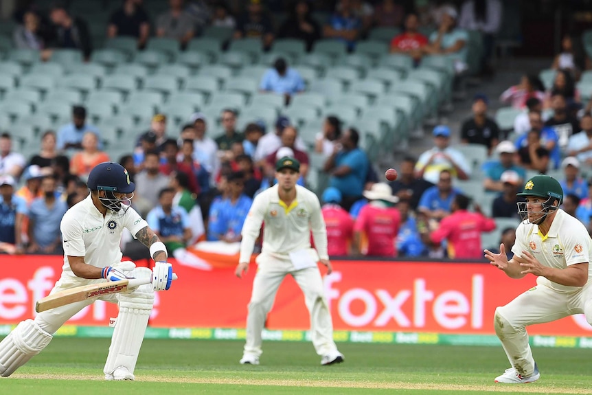India batsman Virat Kohli watches the ball heading towards the waiting hands of Australian fielder Aaron Finch.