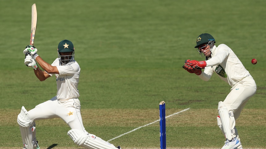 A Pakistan batsman plays a cut as the ball flies past the wicketkeeper. 