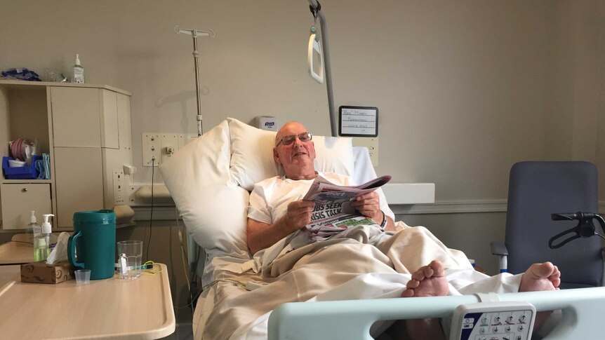 Ron Massie in bed after his knee replacement surgery.