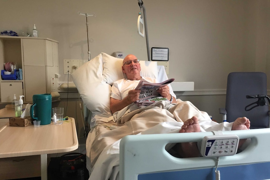 Ron Massie in bed after his knee replacement surgery.