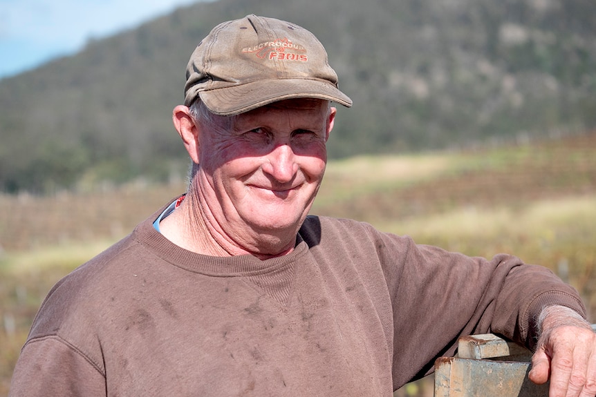 A man in a hat in the vineyards