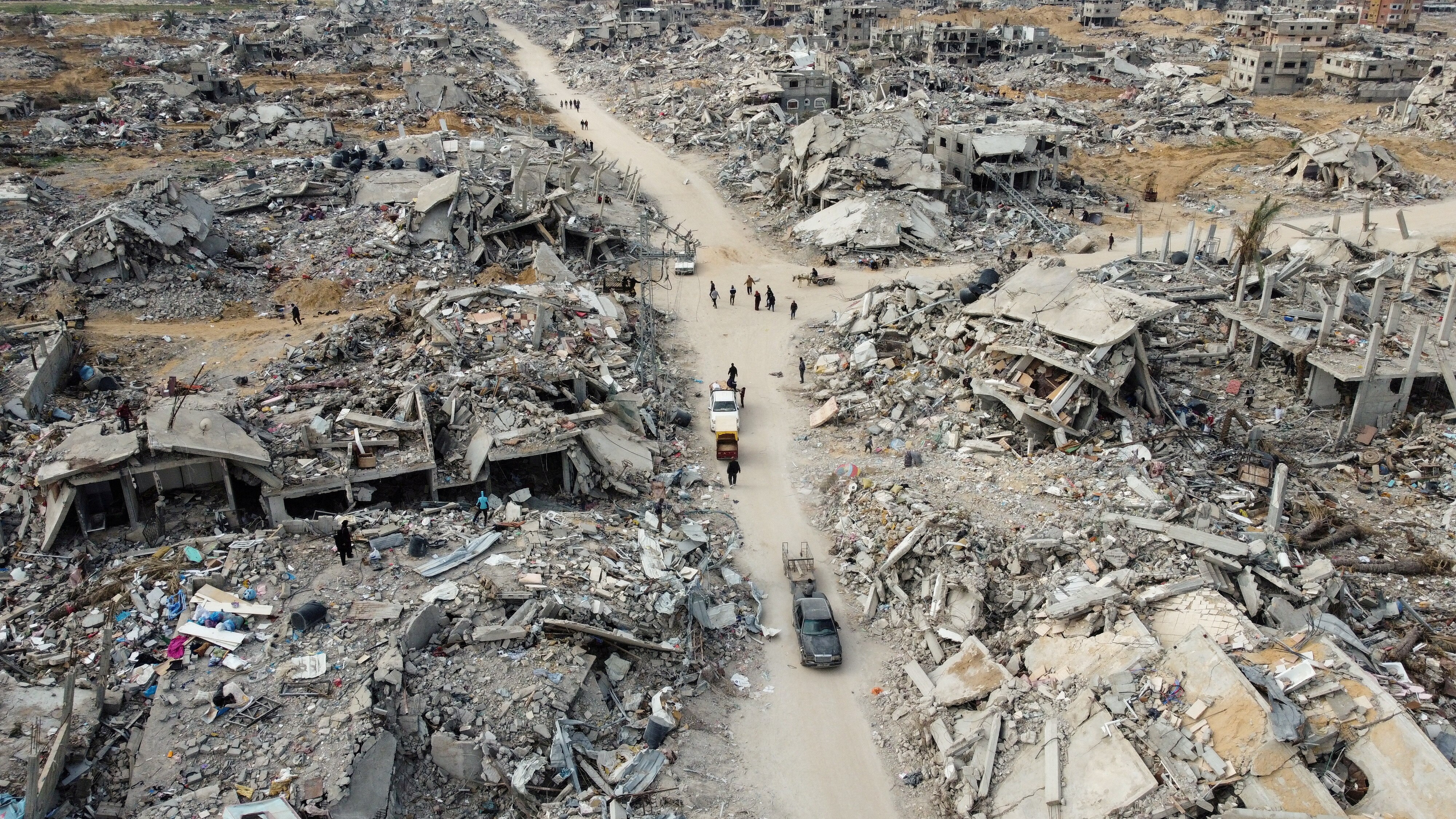 A drone view shows Palestinian houses and buildings lying in ruins.