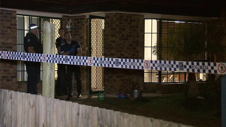Police stand outside Forest Lake house where mum and son stabbed.