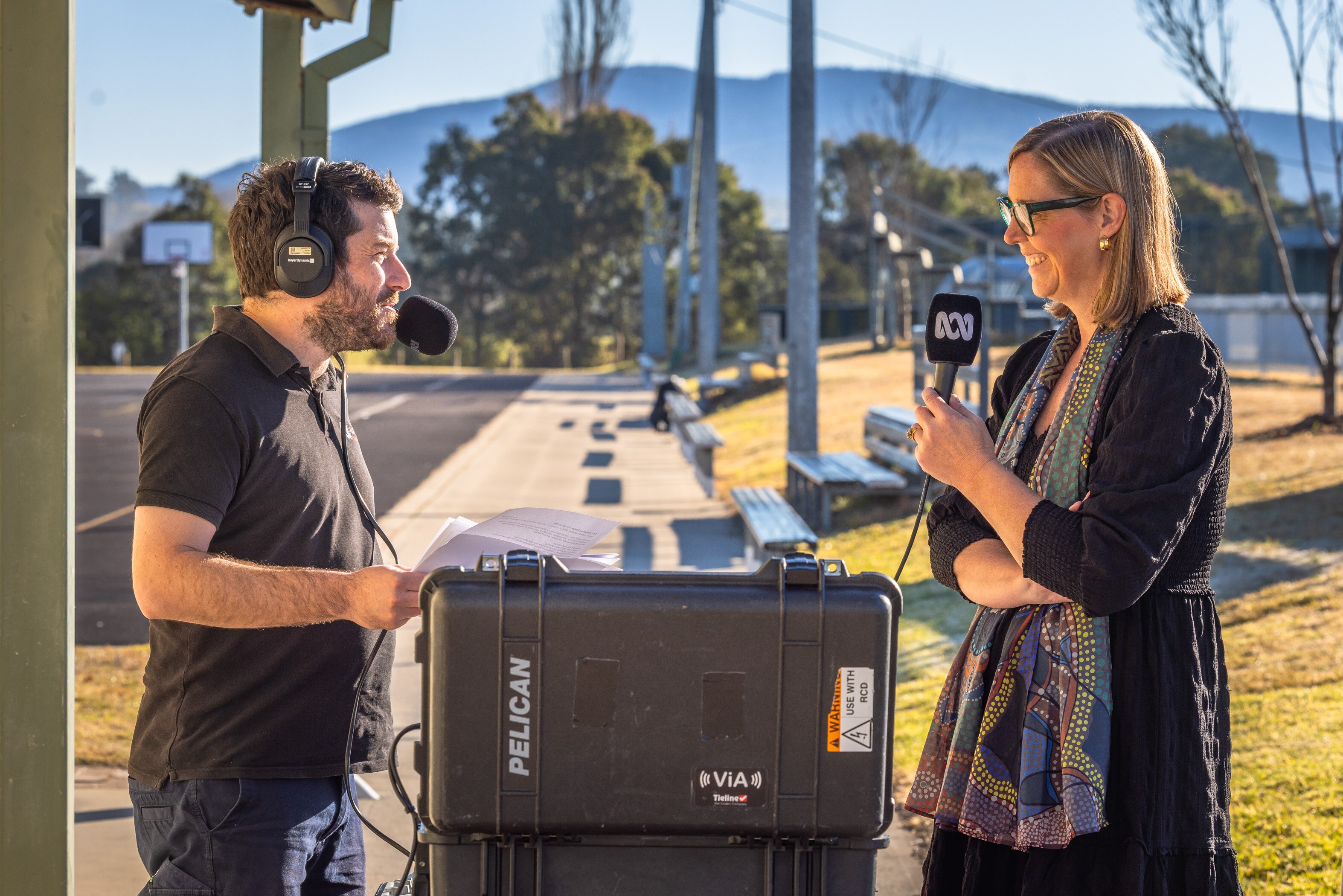 Photo of a radio presenter interviewing a woman